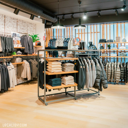 L'intérieur du magasin de vêtements pour hommes Thimister Men à Herve. On y voir des vestes, des pulls et des pantalons homme.