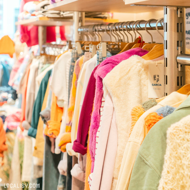 Sélection de vêtements pour enfants en exposition au magasin Ma-au Kids à Spa.