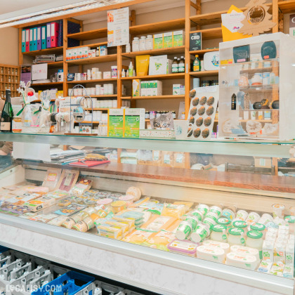 Vitrine réfrigérée du magasin Énergie Bio à Heusy, exposant des produits frais et biologiques comme des fromages, yaourts et autres produits laitiers.